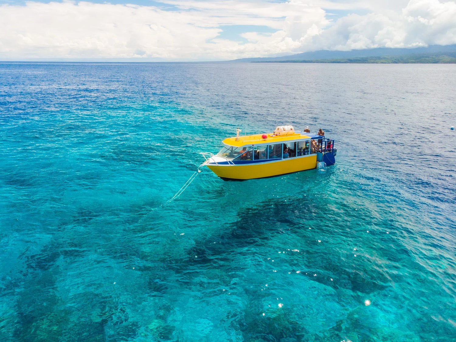 A dive boat moored on Cyclone Reef, off the coast of Papua New Guinea 
